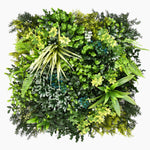 Artificial green wall with various types of greenery on a white background