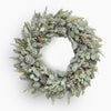 Christmas wreath with pine cones and snow effects on a white background