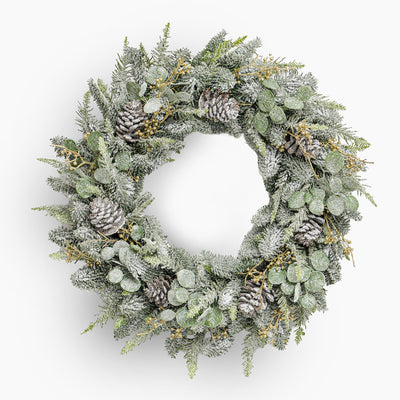 Christmas wreath with pine cones and snow effects on a white background