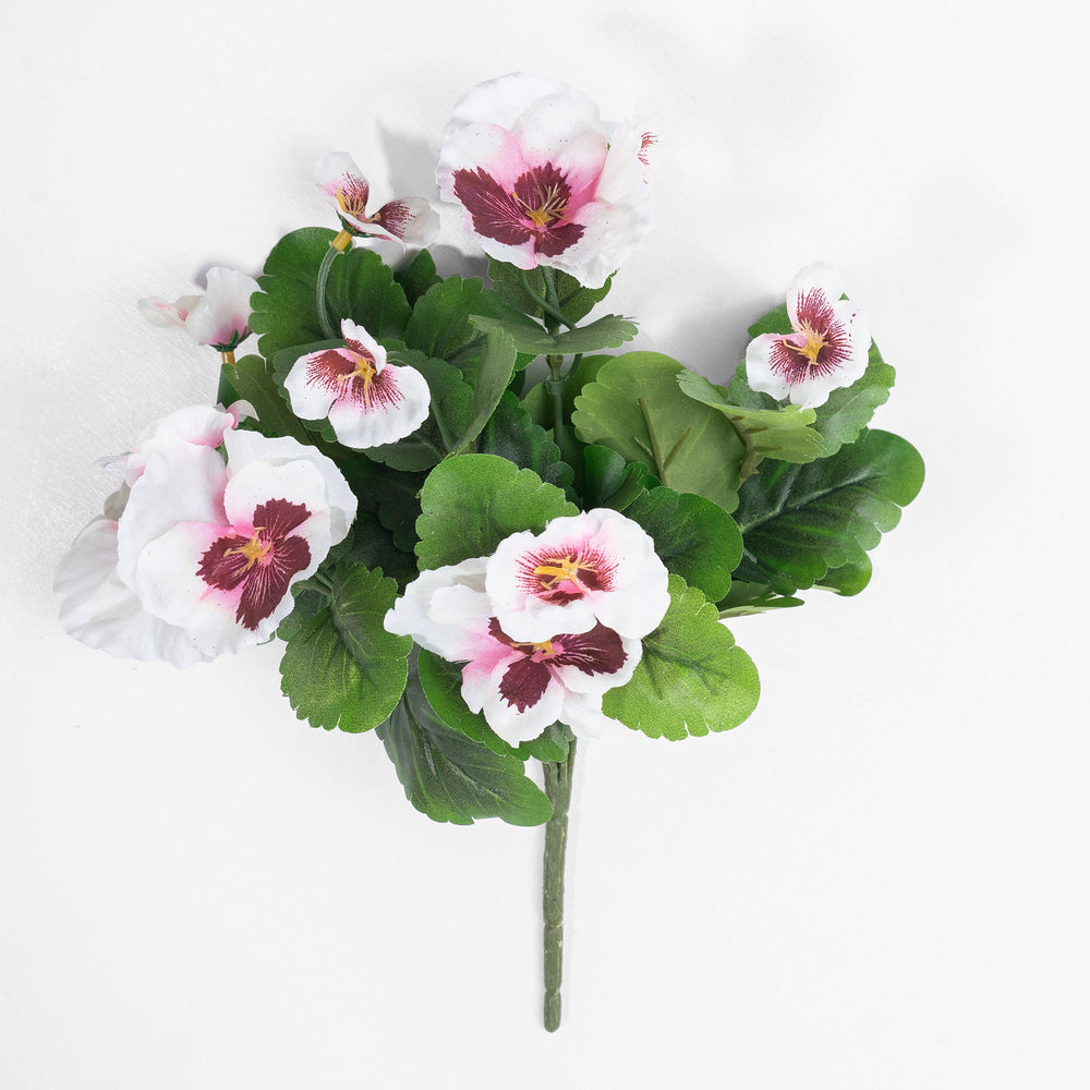 Artificial flower arrangement with white and pink flowers on a white background