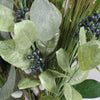 Faux winter foliage berry, eucalyptus and pine bunch close-up