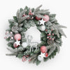 Decorative Christmas wreath with pink and silver ornaments on a white background