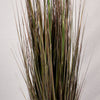 Close up of the thin brown stems of an artificial pampas grass, set against a plain background.