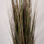 Close up of the thin brown stems of an artificial pampas grass, set against a plain background.