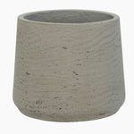 Concrete pot with a textured surface on a white background