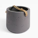 Concrete planter with a rope handle on a white background