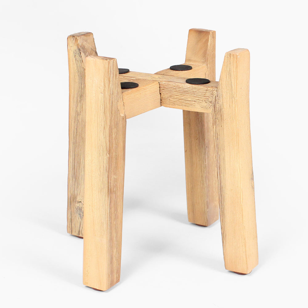 Wooden stool with four legs on a white background