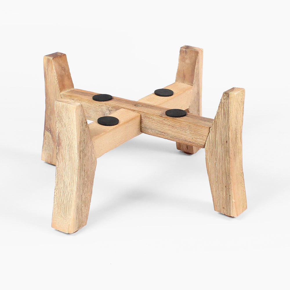 Wooden stool with four legs and circular pads on a white background