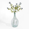 Clear glass vase with greenery on a white background