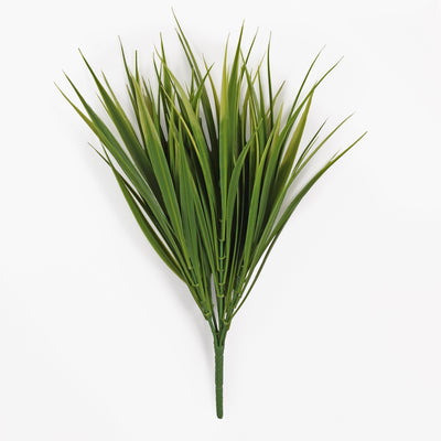 An artificial green grassy plant stem with long, narrow leaves, photographed against a plain white background.