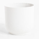 White ribbed vase on a white background