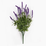 An artificial lavender bouquet with purple flower spikes and green leaves, photographed against a plain white background.