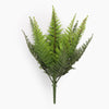 Artificial fern plant on a spike from the side on a white background
