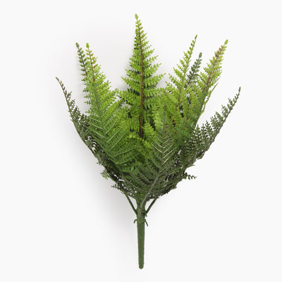 Artificial fern plant on a spike from the side on a white background