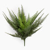 Artificial fern plant on a spike from the side on a white background
