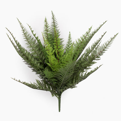 Artificial fern plant on a spike from the side on a white background